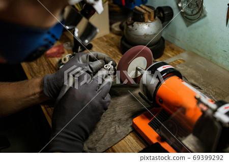 close-up. The jeweler makes a silver ring close-up. The jeweler makes a silver ring 69399292