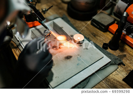 close-up. The jeweler makes a silver ring close-up. The jeweler makes a silver ring 69399298
