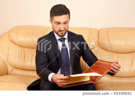 young businessman working with documents. young businessman working with documents. 69399692