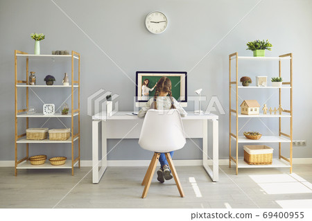 Girl watching online lesson with virtual teacher on laptop at home Girl watching online lesson with virtual teacher on laptop at home 69400955