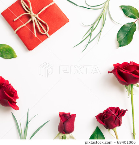 Gift box with red rose flowers on white background. flat lay, top view, copy space Gift box with red rose flowers on white background. flat lay, top view, copy space 69401006