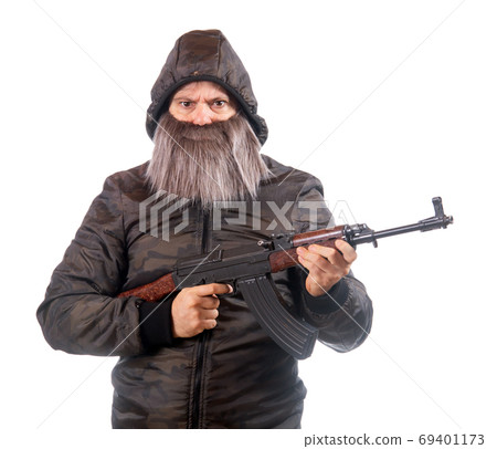The bearded man armed with kalashnikov isolated on a white background. Warrior with automatic weapon 69401173