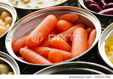 Canned baby carrots in just opened tin can. Non-perishable food 69401308