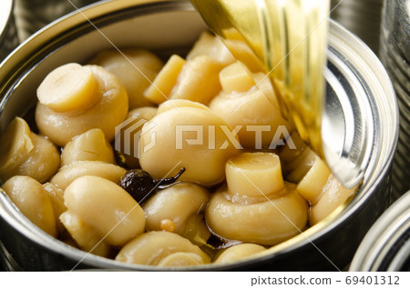 Canned button mushrooms in just opened tin can. Non-perishable f 69401312