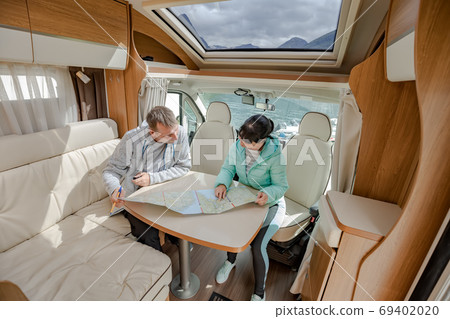 Couples in RV Camper looking at the local map 69402020