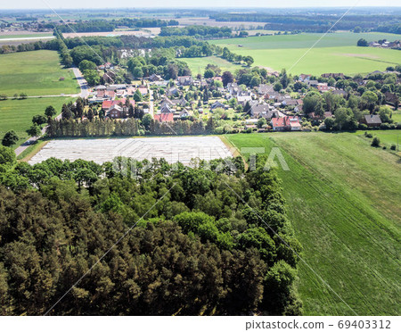Aerial view of a small village in the distance  69403312