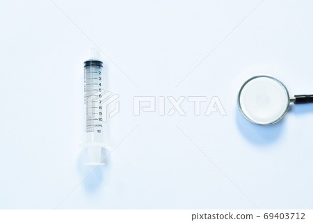 syringe and stethoscope medical equipment for doctor listening pulse of patient on white background syringe and stethoscope medical equipment for doctor listening pulse of patient on white background 69403712