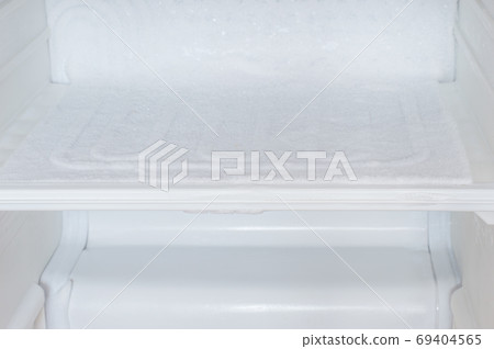 Ice buildup inside of empty of a refrigerator. Ice buildup inside of empty of a refrigerator. 69404565