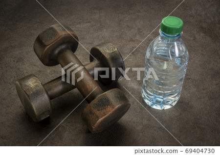 dumbbells and bottle of water dumbbells and bottle of water 69404730
