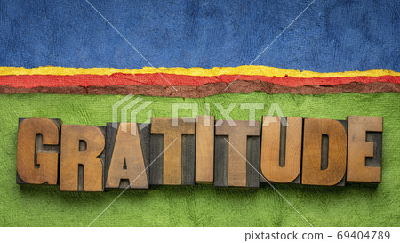 gratitude word in wood type against abstract landscape 69404789