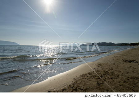 View of the beach on zvernec. On the horizon is the Peninsula of Karaburun and the island of Sazan. 69405609