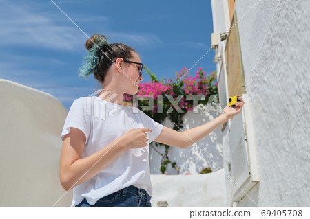 Teenager girl blogger recording video vlog from luxury travel to Mediterranean Teenager girl blogger recording video vlog from luxury travel to Mediterranean 69405708