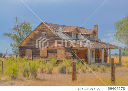 A rustic, rundown, old abandoned, ruined, farm house in the countryside of a prairie in Colorado A rustic, rundown, old abandoned, ruined, farm house in the countryside of a prairie in Colorado 69406278