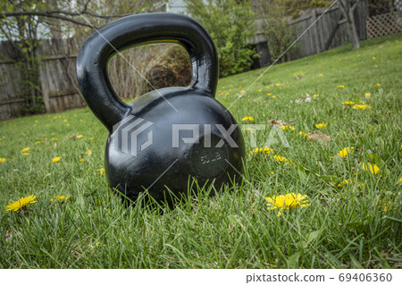 kettlebell on grass - backyard fitness 69406360