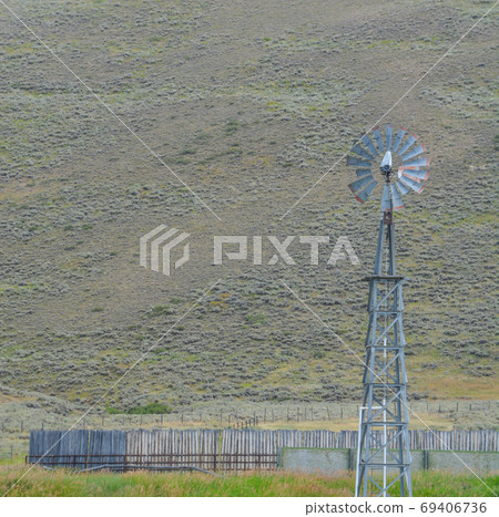 This wind mill is pumping water for horses on this farm in Colorado. This wind mill is pumping water for horses on this farm in Colorado. 69406736