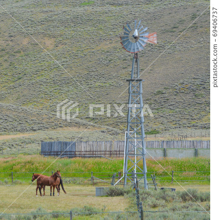 This wind mill is pumping water for horses on this farm in Colorado. This wind mill is pumping water for horses on this farm in Colorado. 69406737