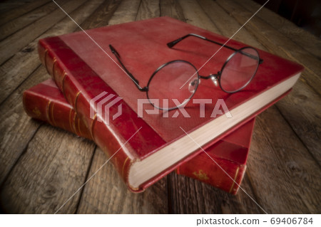 antique books and reading glasses - pinhole image 69406784