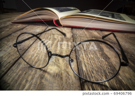 reading glasses and book - pinhole image 69406796