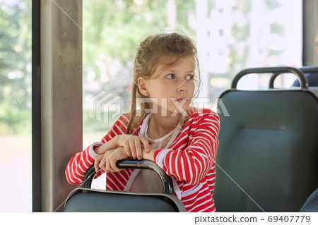 Child passenger of city bus, trolleybus, girl sitting in passenger seat Child passenger of city bus, trolleybus, girl sitting in passenger seat 69407779