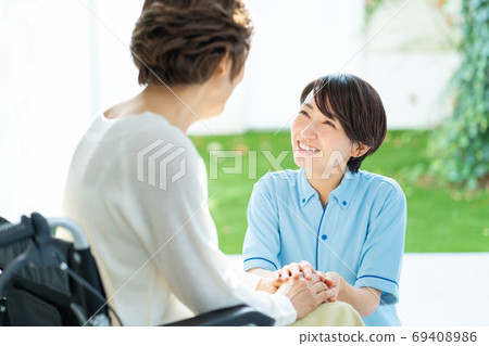 Nursing care wheelchair caregiver senior woman medical image 69408986