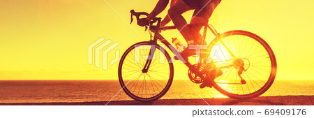 Cyclist biking on road bike sunset banner Cyclist biking on road bike sunset banner 69409176