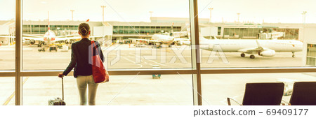 Traveler businesswoman at airport banner Traveler businesswoman at airport banner 69409177