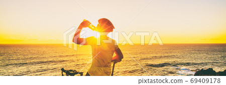 Athlete cyclist man drinking water on bike Athlete cyclist man drinking water on bike 69409178