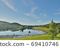 A lush plateau and a quiet lake illuminated by the refreshing light of the morning 69410746