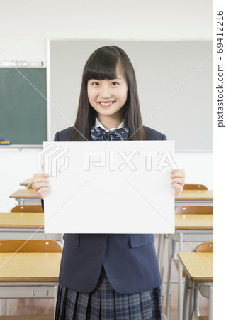 Female students with message board Female students with message board 69412216