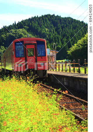 Red local train departing from the station 69414003