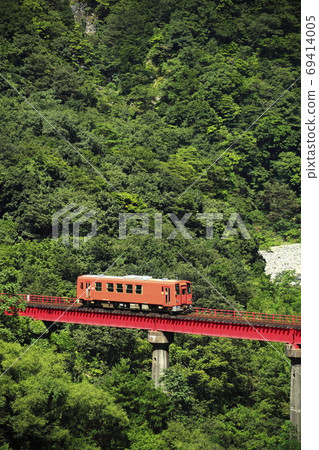 Local train running on the red iron bridge 69414005