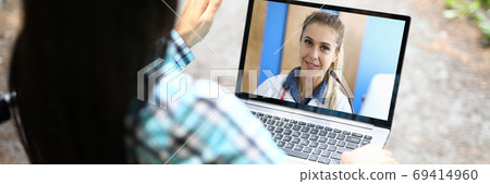 Fmale disabled person on wheelchair talk online with beauty doctor Fmale disabled person on wheelchair talk online with beauty doctor 69414960