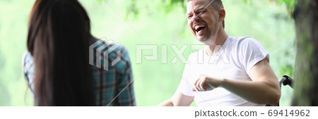Male disabled man with girlfriend smiling on park walk portrait Male disabled man with girlfriend smiling on park walk portrait 69414962