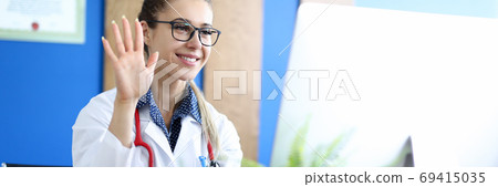 Young caucasian female doctor talking with patient against hospital office background portrait. 69415035