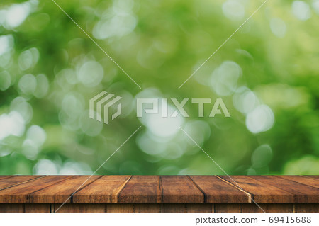 Empty wood table and green bokeh blur with copy space display mo 69415688