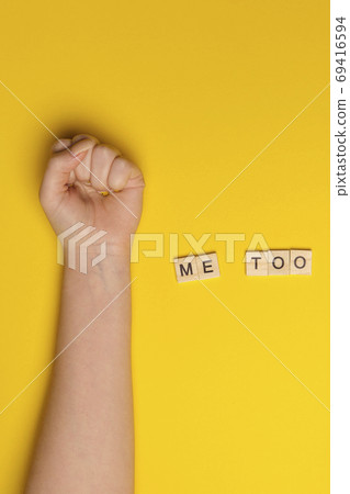 MeToo on wooden alphabet, used for concept of sexual harrassment. Woman fist as protest in shot MeToo on wooden alphabet, used for concept of sexual harrassment. Woman fist as protest in shot 69416594