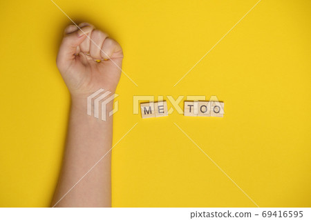 MeToo on wooden alphabet, used for concept of sexual harrassment. Woman fist as protest in shot MeToo on wooden alphabet, used for concept of sexual harrassment. Woman fist as protest in shot 69416595