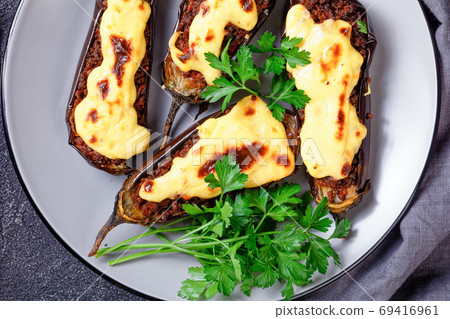 Papoutsakia stuffed eggplants, top view, flat lay Papoutsakia stuffed eggplants, top view, flat lay 69416961
