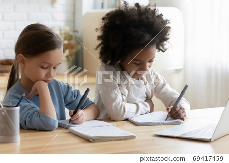 Little mixed race kids enjoying online educational class. 69417459