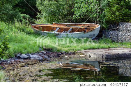 A broken boat is pictured on the banks of Loch Leven in the Scottish highlands. A broken boat is pictured on the banks of Loch Leven in the Scottish highlands. 69417557