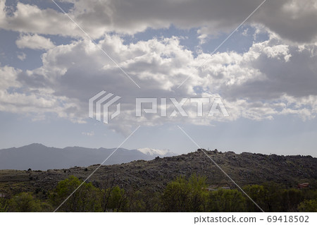 Landscape of a valley at the foot of a mountain 69418502