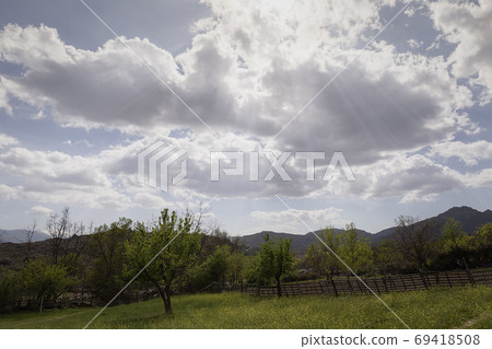 Landscape of a valley at the foot of a mountain 69418508