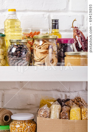 Set of non-perishable foods on pantry shelf on brick wall backgr 69419893