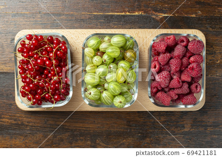 Assorted berries of raspberries, gooseberries and red currants Assorted berries of raspberries, gooseberries and red currants 69421181