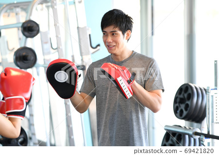 Male trainer holding a mitt Male trainer holding a mitt 69421820