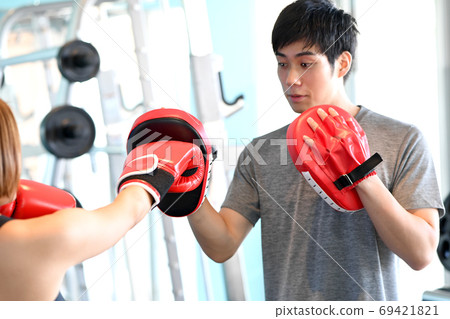 Male trainer holding a mitt Male trainer holding a mitt 69421821