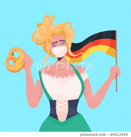 woman holding salty pretzel and flag Oktoberfest party celebration waitress wearing mask to prevent coronavirus 69422956