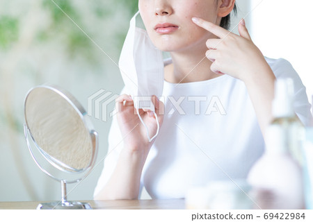 A young woman who is worried about rough skin because of a mask, no face 69422984