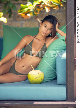 Beautiful, young asian women in a bikini - Stock Illustration