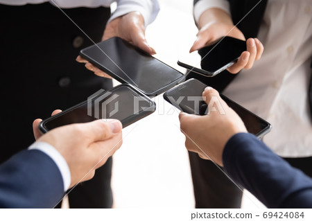 Close up of diverse businesspeople using smartphones 69424084